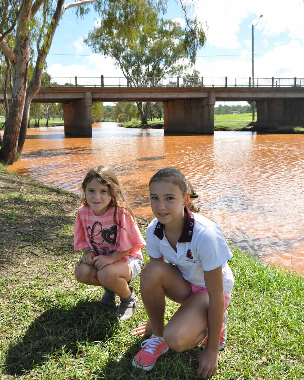 Mia and Madi Ammenhauser wonder if the Condamine River is flowing with chocolate.